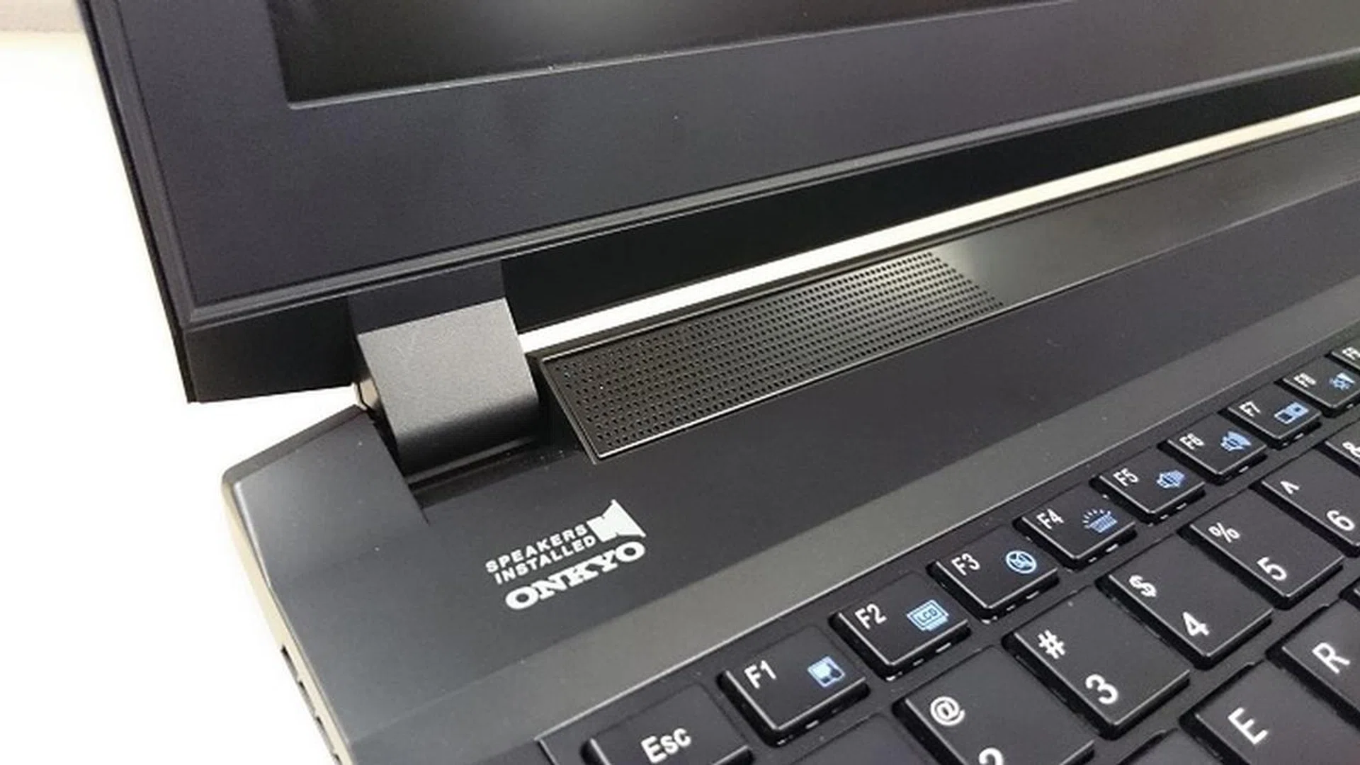Below the screen and next to the hinge, you’ll find a 2W Onkyo speaker on each side.