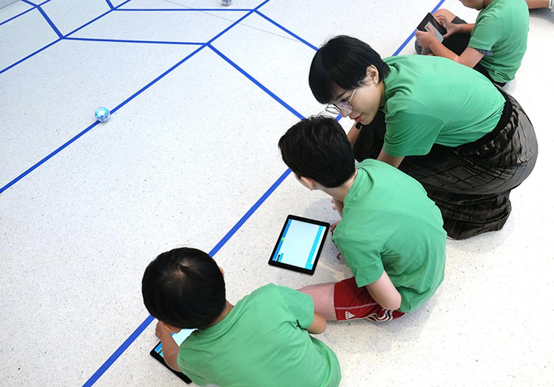 The first mission requires children to program their Sphero robots to roll to the first blue line in front of them.