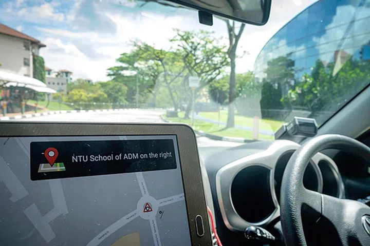 The tablet, attached to the test vehicle's smart on-board unit, displays landmark information. The V2X-linked vehicle can receive such messages from the V2X communication system. (Image source: NTU, Singapore) 