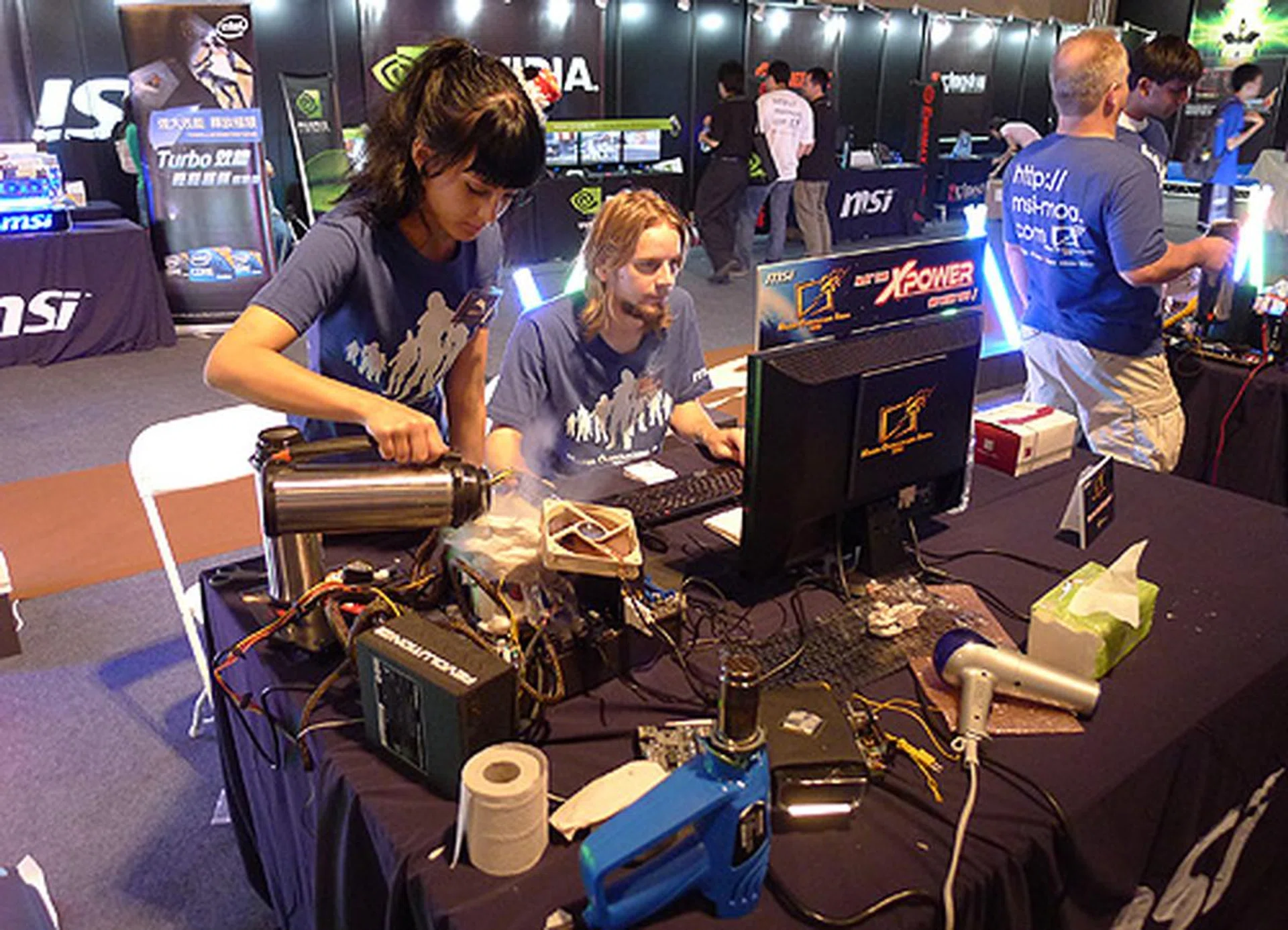 Mink from Team Laddergoat adding liquid nitrogen while Mean Machine looks on in hopeful anticipation.
