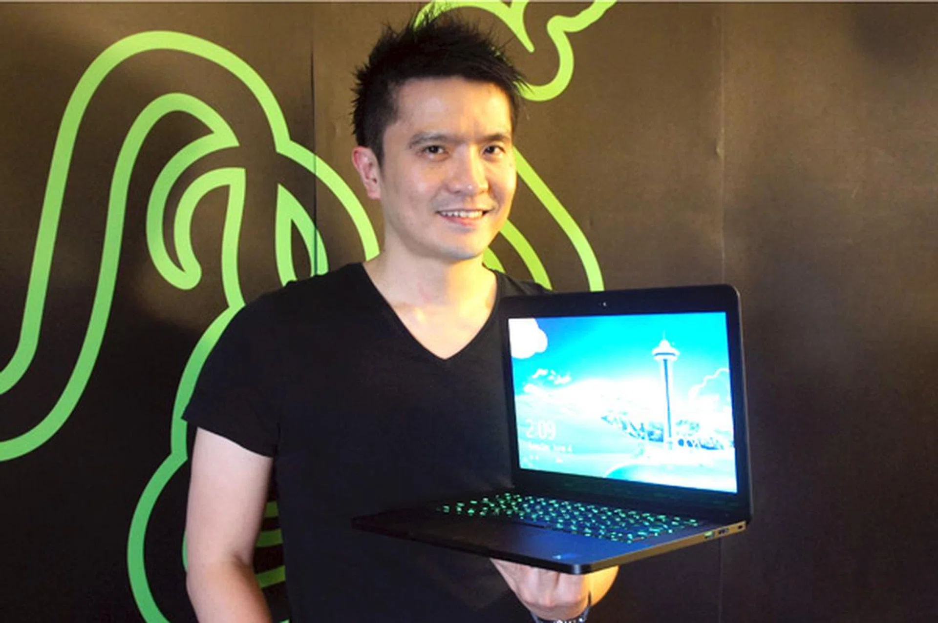 Razer CEO Min-Liang Tan posing with the new 14-inch Razer Blade gaming notebook.