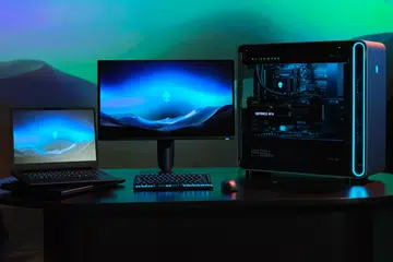 Alienware Area-51 laptop, 27-inch 4K QD-OLED gaming monitor and Area-51 desktop. This is someone's downpayment for a car loan on a table. Photo: Dell.