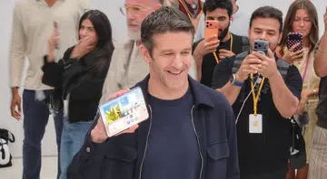 John Ternus holding iPhone Duo