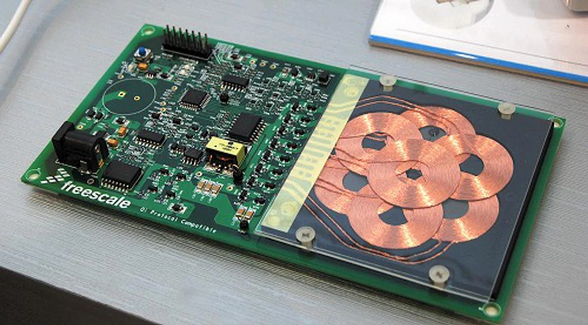 Shown in here in their booth is a wireless charging transmitter pad reference design aimed at mobile phones. The multi-coil array design in the transmitter unit allows for more care-free positioning of the mobile device (receiving unit) where only selective coils are activated for charging.