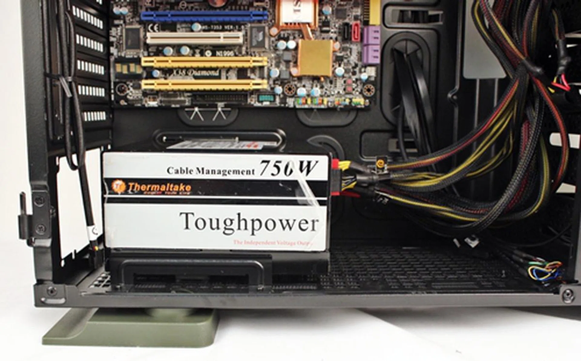 Sliding the PSU in place with the rails for guidance, we secured it in place with four rear screws. There is also an option to install a 120mm cooling fan next to the PSU.