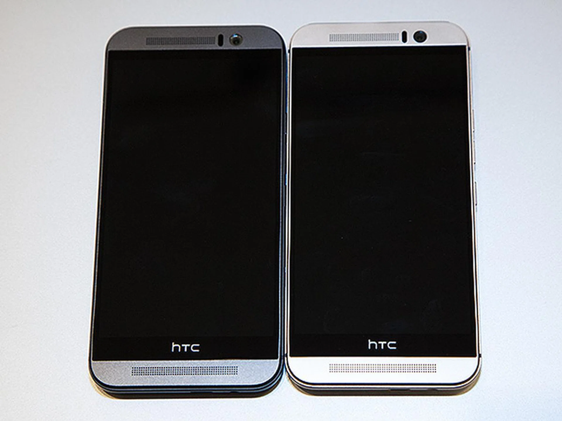 The new HTC One M9 comes in three different colors. Shown here is the gunmetal grey version (on the left) and the two-tone gold on silver design (on the right).