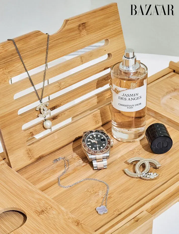 Wong has a penchant for timelessness; here, a Chanel necklace and brooch, a Van Cleef & Arpels Alhambra necklace and a Rolex timepiece sit alongside the Jasmin des Anges fragrance by Dior.