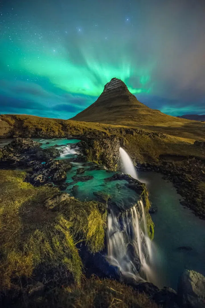 The beauty of Kirkjufell Mountain is in its nearly symmetrical shape and freestanding location—which is probably why it's the most photographed mountain in Iceland. It's also a particularly beautiful spot to watch the Northern Lights when they're active from October to March. Photo: Getty