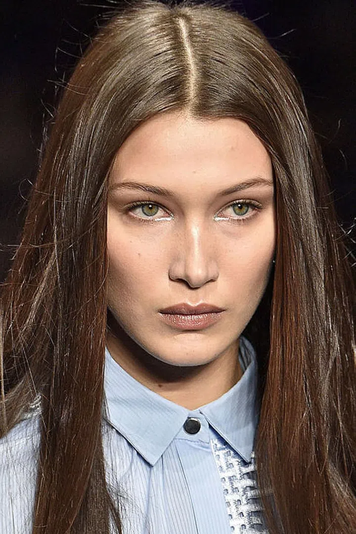 At Versace, makeup artist Pat McGrath used the silver pigment from her Metalmorphosis collection to highlight the inner corner of the eyes as well as the cheeks, nose, and cupid's bow.