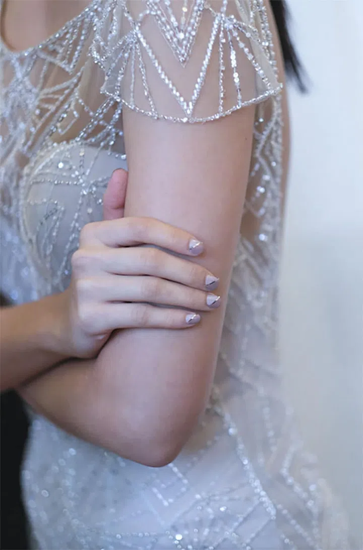 Don't get suckered in to wearing a simple nude nail polish for your big day if it's not something you'd wear any other day of your life. At the very least, add a metallic stripe across the nude nail polish for a light-catching and simple upgrade.