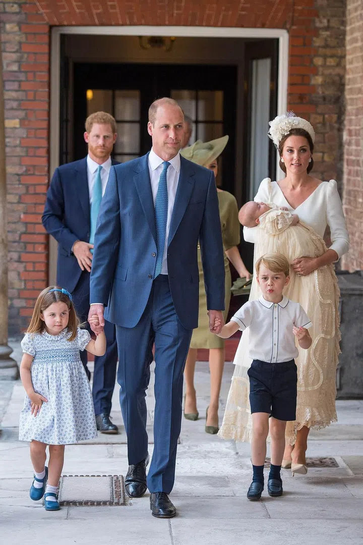 Princess Charlotte and Prince George hold on to dad Prince William's hands as they enter the chapel in coordinating blue and white outfits. Photo: Getty

