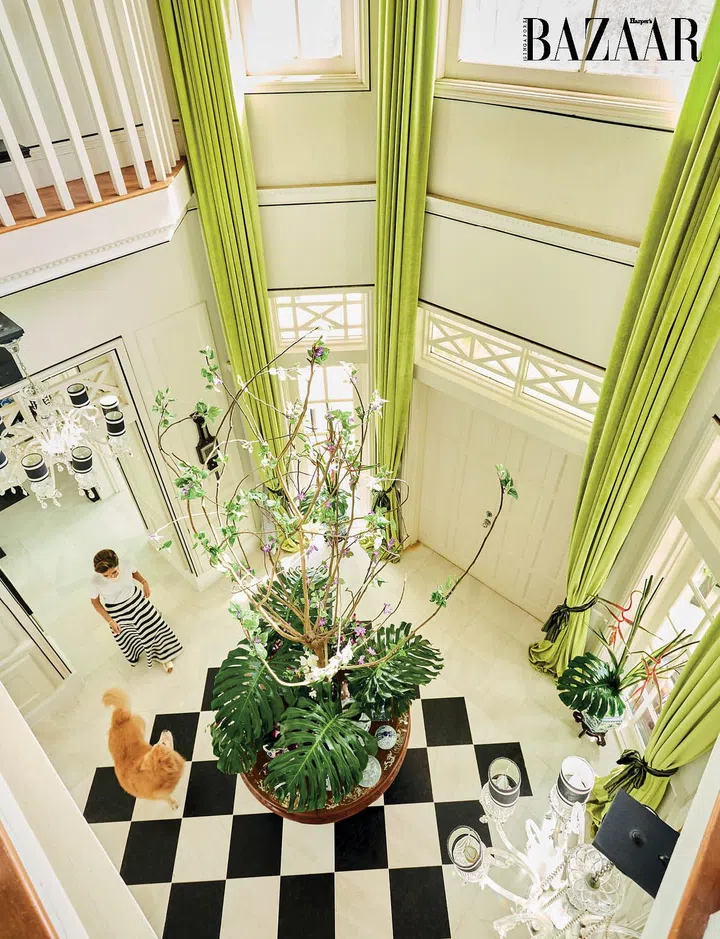 Hunt with her dog, Simba, in the airy foyer which has a chic, checkerboard floor, and drapes that echo the colour and material used throughout the rest of the first level. 