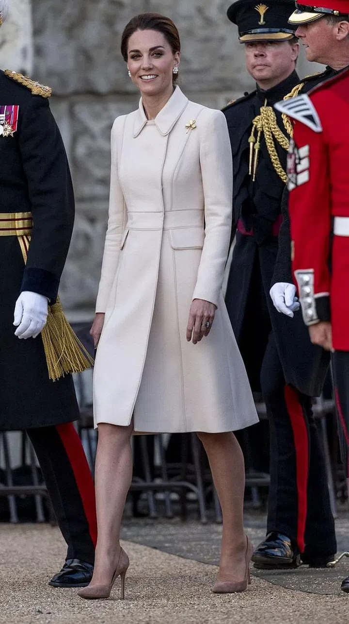 Kate Middleton was among the attendees at this year's Beating Retreat, an annual concert held by the Household Division, the seven British army regiments serving the queen. For the event, the Duchess wore a white coat by Catherine Walker with a mauve clutch by Mulberry and neutral suede heels. She kept her hair up in a clean bun and accessorized with a gold shamrock pin in a nod to the Irish Guards.