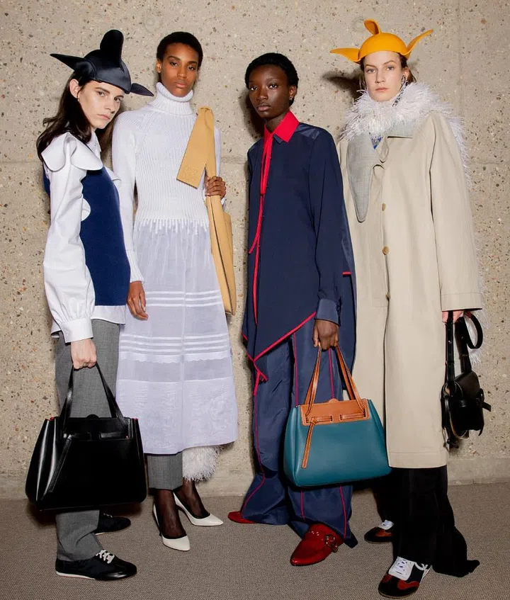Jonathan Anderson’s past few collections have shown an emergence of a more grown-up sensibility. This latest Loewe collection might be his most restrained and focused yet, making it highly covetable. At its core were thoughtfully considered clothes elevated by the kind of rich, artisanal craftsmanship that Anderson has so artfully woven into the fabric of Loewe’s essence. Dresses that started as cable knit or leather on top might seamlessly end as cotton linen, silk satin or fur below—showcasing Anderson’s knack for making intricate craft look easy. There was a tinsel skirt
corded to a black leather waist, paired with the simplest chic white blouse; and a sweater entirely encrusted in pearls, but worn off handedly with wide indigo jeans. Mouse-eared hats added touches of whimsy and levity.