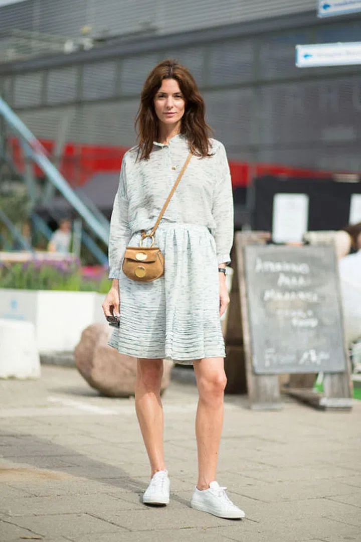 For an unexpected combo, pair your sneakers with a girly silhouette in the form of a flared skirt or dress.Photo: Diego Zuko 