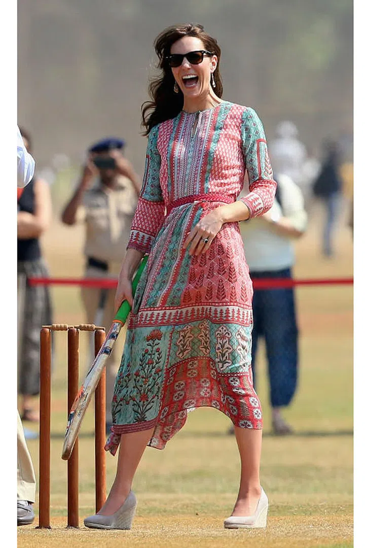 Kate Middleton shows off her cricket skills during a visit to meet children from Magic Bus, Childline and Doorstep, three non-governmental organizations, at Mumbai's iconic recreation ground, the Oval Maidan. The Duchess of Cambridge wore a dress by Anita Dongre, one of India's most well-known designers, and wedges from Monsoon. Photo: Getty