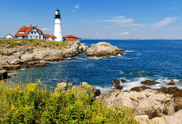 As far as quintessential New England destinations go, Portland is high on the list—especially during the summer, when days can be spent taking sailboat rides with Portland Schooner Co. and eating lobster rolls at classic waterfront restaurants like Portland Lobster Company.

Make your base the new Francis hotel, which has the intimate feel of a B&amp;B—only a luxurious one whose 15 clean-lined rooms have hardwood floors, touches of blue and grey, and mini-bars that feature local items like Liquid Riot whiskey and canned cocktails from Maine Craft Distilling. Through October 31, you can sign up for a bike tour through Summer Feet Cycling for a ride that will take you to five lighthouses, including Portland Head Light.

For a romantic stroll, head to the Eastern Promenade, which has views of boat-filled Casco Bay, surrounding islands, and Fort Gorges. And Kittery favorite Bob’s Clam Hut opened a Portland location last week in an area brimming with restaurants, including the Drifters Wife, a gastropub known for its natural wine list. If you want to be in-the-know about the city’s food and drink scene, sign up for the newsletter from Eat Drink Lucky before you depart.
Photo: Getty