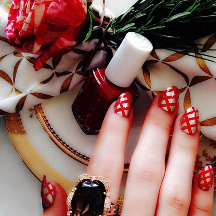 Bold red lines painted over a metallic polish remind us of perfect holiday presents. @michellesaunders
