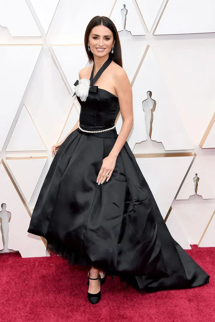 What: Chanel

Why: The ageless actress is wearing a custom gown based off a dress from the house's 1995 Haute Couture collection, complete with camellia flower, a pearl belt, a bow, and an asymmetrical hemline. In other words, all of our Chanel dreams come true. Photo: Getty