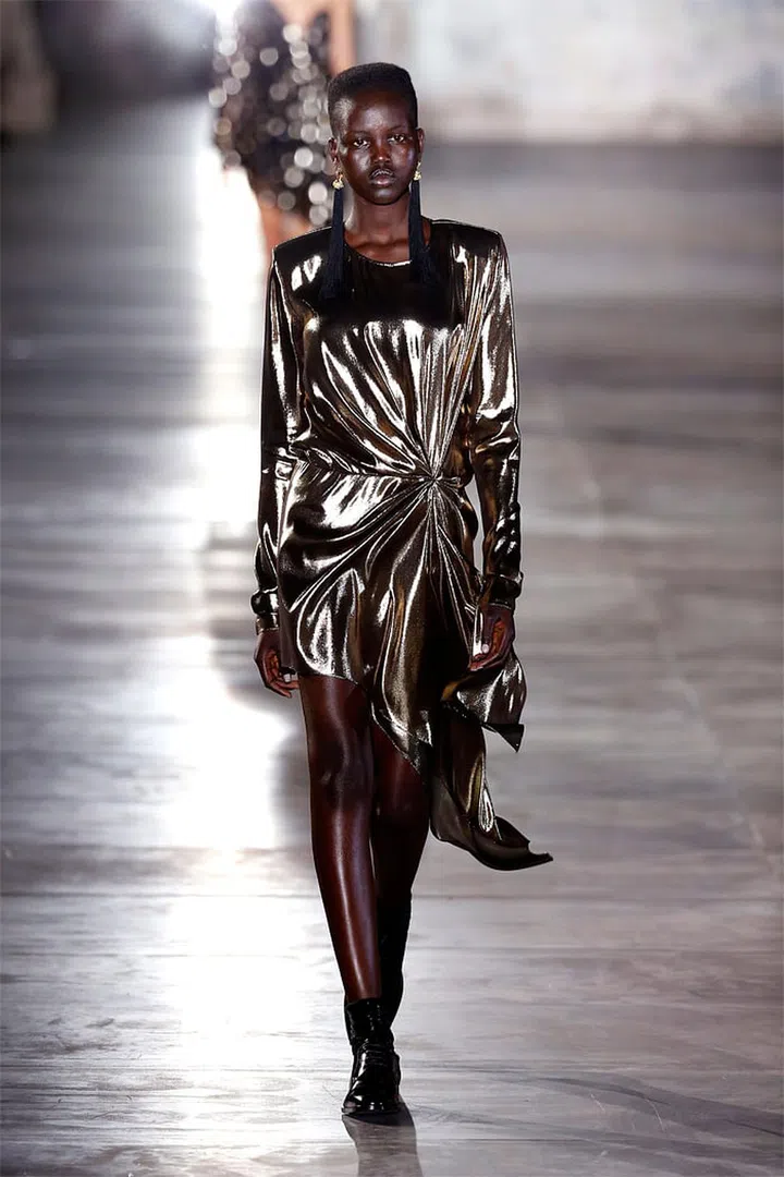 Where Slimane preferred a California '90s rocker vibe, Vaccarello is drawing on '80s YSL for references. See: the poof-shouldered mini dress, the gold lamé, and the one-shouldered silhouette. Photo: Getty
