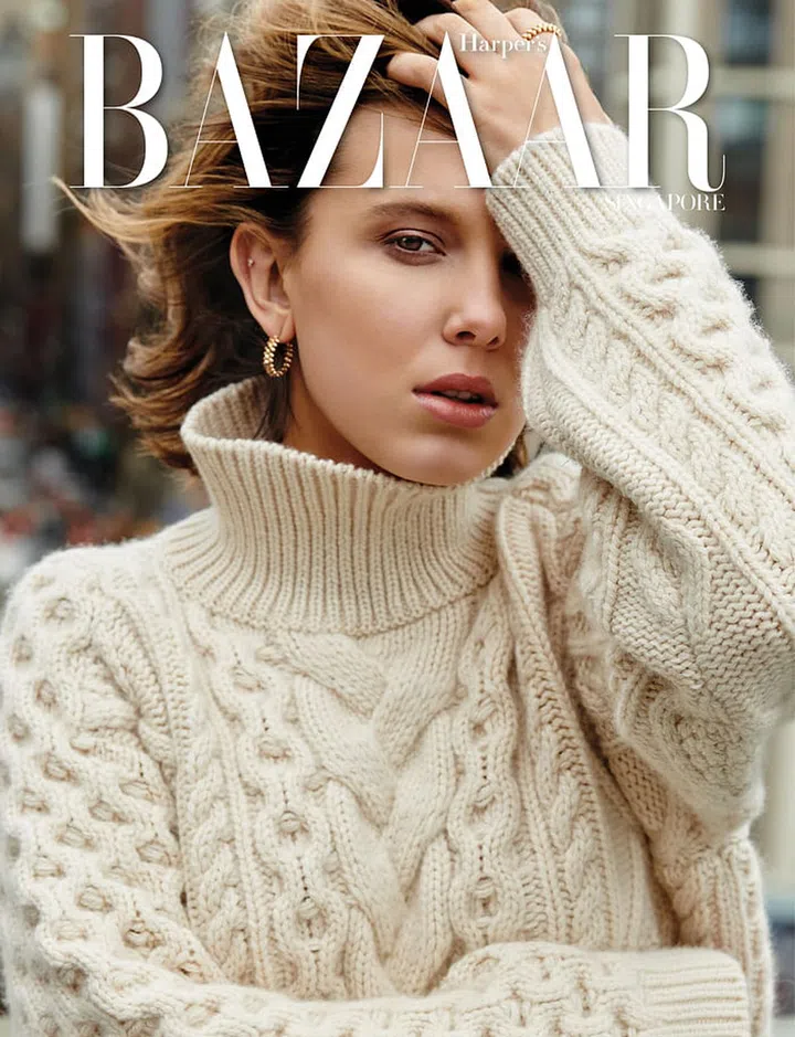 Millie Bobby Brown wears sweater, CELINE by Hedi Slimane. Gold Clash de Cartier earring; gold Clash de Cartier ring, Cartier. Photo: Yu Tsai