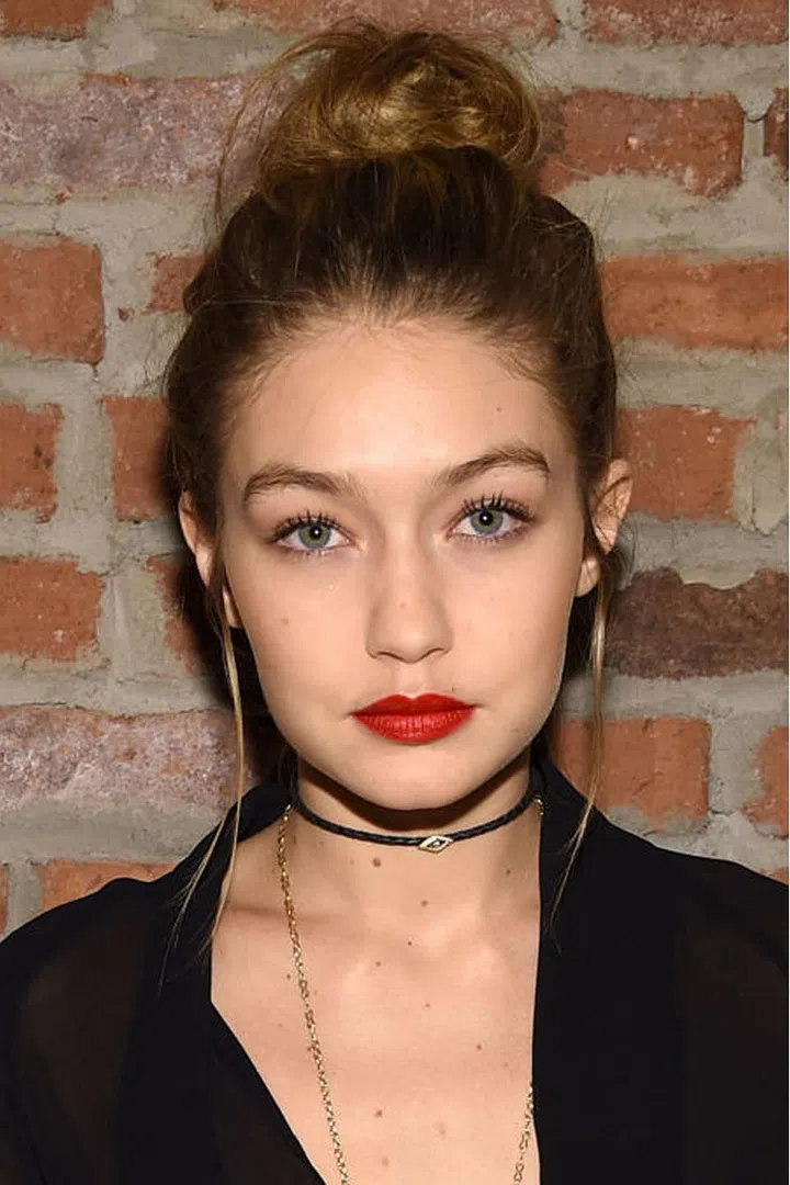 Tugging down long strands in front of her ears gave Hadid's top knot a bit of balance.
Photo: Getty