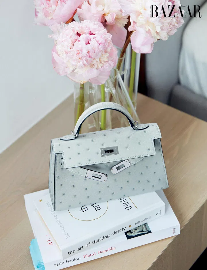 Wu’s ostrich skin Hermès Kelly bag sits atop her bedside reads. 
Photo: Gan