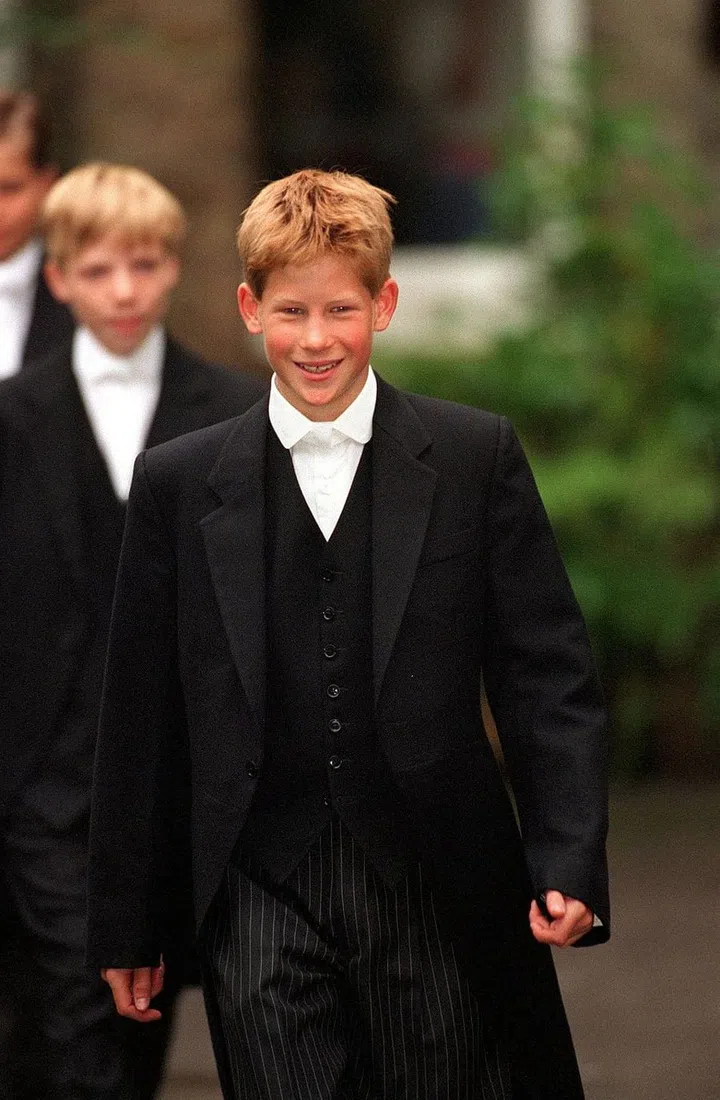 On the cusp of 14, Prince Harry leaves his school house for his first day at Eton College wearing the traditional Eton tail coat.