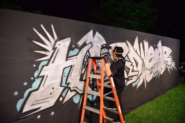 Street-art artist Jahan Loh working on a five-metre wide graffiti art piece at the event
