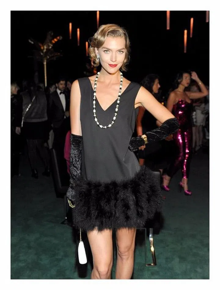 The model makes for a 1920s vision with a gold Panthère de Cartier watch on her wrist 