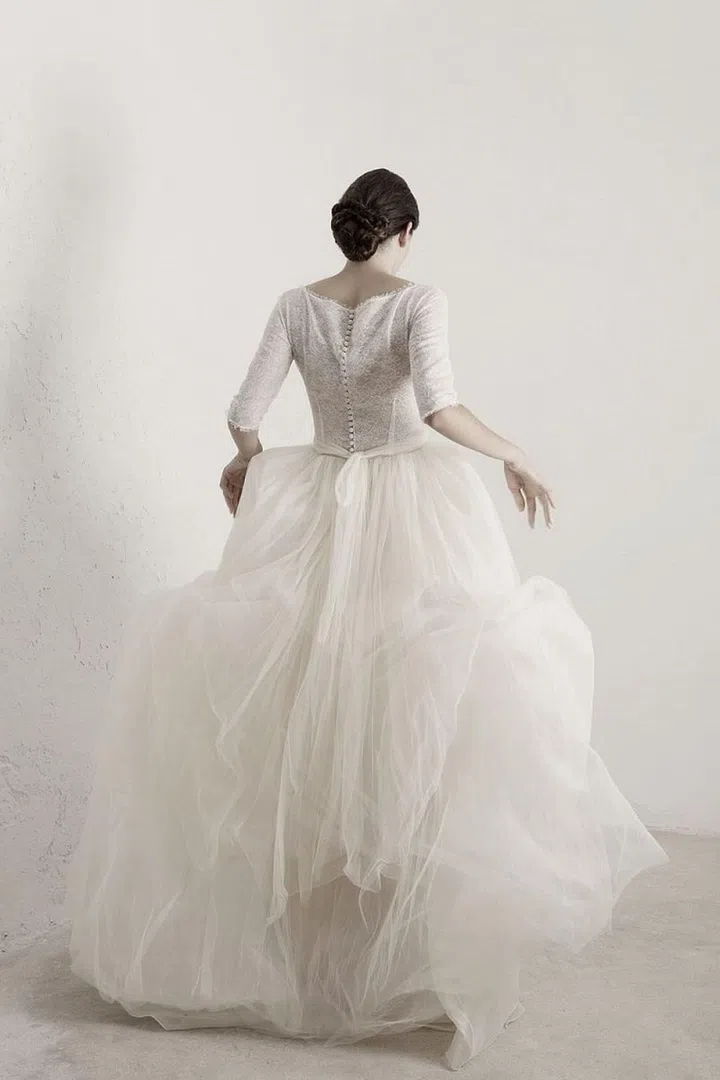 If you've hit your local bridal salons and department stores and find that most gowns are far too stuffy, stiff or overwrought for your taste, this brand gets you. Fine fabrics are this Barcelona-based brand's forte, spinning multi-ply charmeuse, chiffon and silk tulle into slim sheaths and fuller skirts that feel equal parts low-key and traditional. Delicate touches like a frayed edge or a wider weave in their fabrics feel special, not unfinished, and design details that amplify comfort (like ballgowns that are actually separates in disguise) are hidden throughout the brand's range.