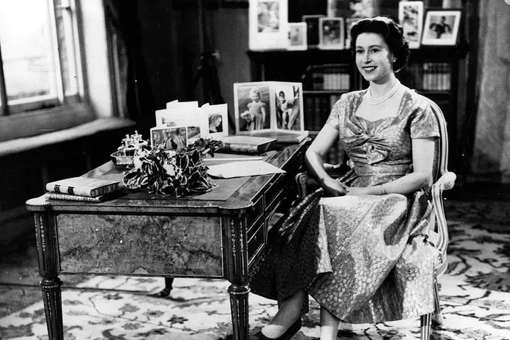 Since 1952, Queen Elizabeth has delivered a Christmas message, which is usually recorded in advance and aired on December 25. (She's only missed one year, in 1969.) This photo is from her first televised message, in 1957. Though you can't see him, Elizabeth is smiling at an off-camera Prince Philip.