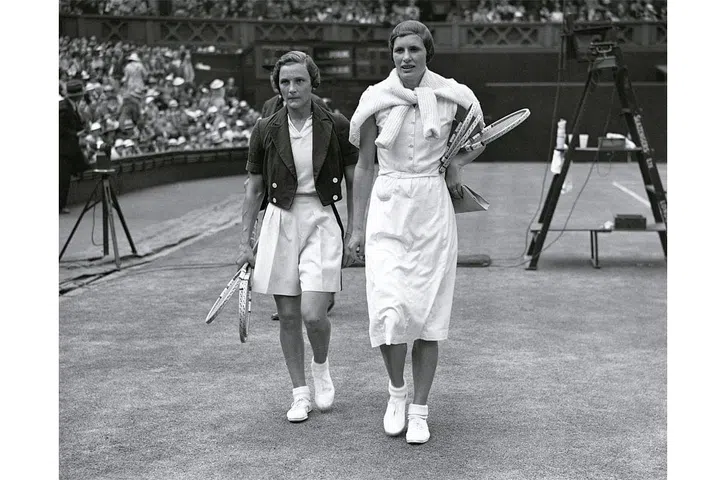  Helen Jacobs (left) and Mrs Sperling leaving the court at Wimbledon. Photo: Getty