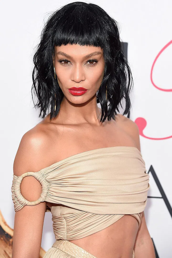 A shag wig worn with patent red lips gives a moto-chick vibe for one night only.