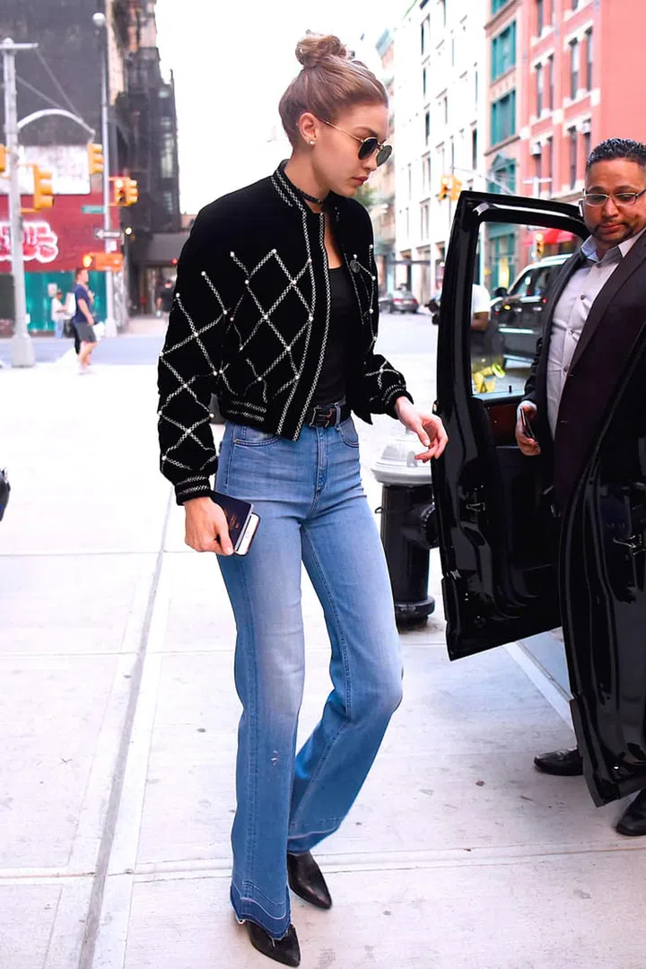 In a detailed bomber jacket, frayed flair jeans, pointed-toe boots, rounded sunnies and an Hermès belt while out in NYC. Photo: Getty