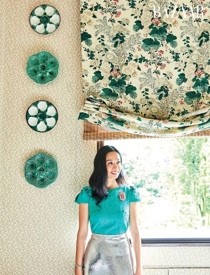 Long in the guest bedroom wearing an Ambali Fashion top, Diane von Furstenberg skirt and a handcrafted Céleste Mogador brooch.