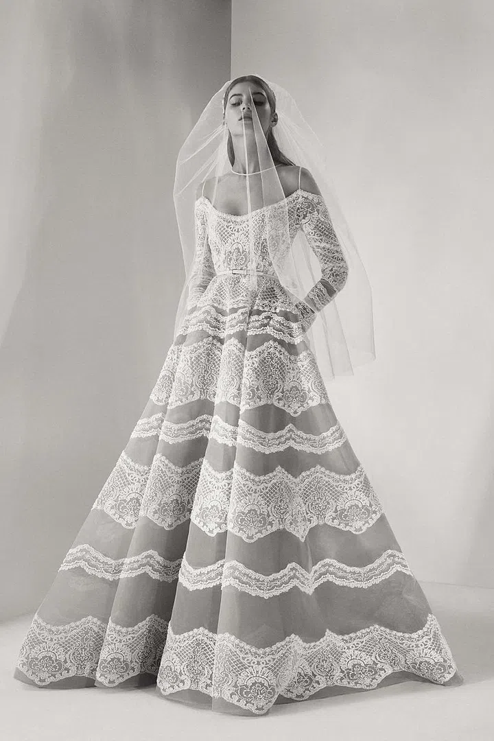 We're well aware that this isn't necessarily a new name to know–but their bridal collection is well worth noting. Let's be real, this is one of the labels we've been dying to have design made-to-order bridal for ages. With two seasons of bridal under their belt, Elie Saab no longer caters to brides solely in a Couture capacity. Now, rather than hopping on a plane to Paris for private atelier appointments and fittings (which you can still do, and it's fabulous), you can also visit boutiques in Miami, New York City, Beverly Hills and in 12 other countries to try on gowns from the brand's bridal range. The gowns are as you'd expect from the runway vet and Haute Couturier–beautifully executed, undeniably romantic, lace-heavy and absolutely breathtaking. Unlike most bridal lines who focus solely on the gowns, Elie Saab launched with a full range of accessories and toppers for the bride, so brides with the budget to do so can style themselves from head-to-toe.