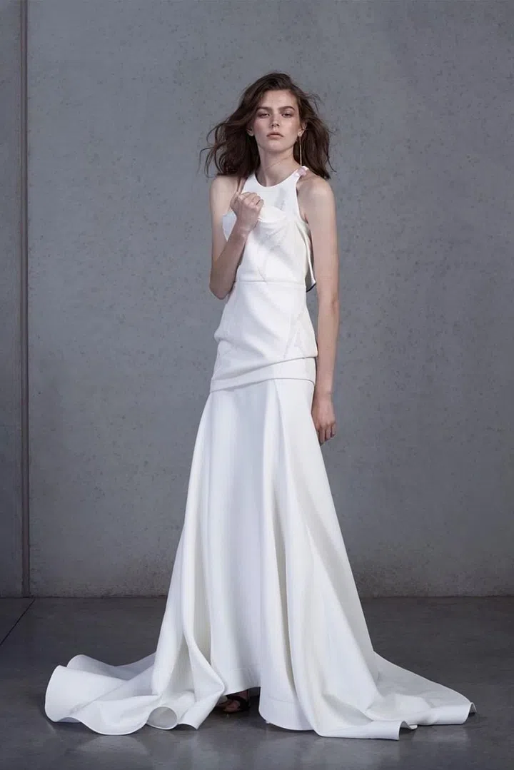 Neoprene mesh ballgowns, velvet flocked dots on organza draped skirts and horsehair trimmed tops are only some of the innovative details designer Toni Maticevski has used in his inventive ready-to-wear label. He's translating them effortlessly into a bridal capsule this season, and is also catering to brides for bespoke gowns in his Australia-based atelier. Maticevski experiments with shape and scale consistently, always creating something that feels undoubtedly new. For the bride whose a mainstay on the gala circuit or has been a bridesmaid one-too-many times (and requires a bridal gown that feels like a departure from her black-tie uniform), this is a brand that should be on your radar.