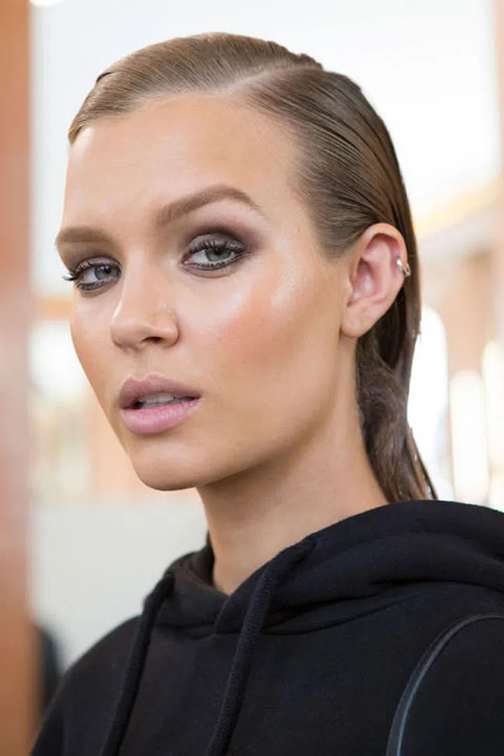 The Look: Sexy Pool Hair
How-To: You can always count on the Balmain show to serve-up sexy hair, whether it's in a super-high ponytail or soft wave. This year, like so many others shows, the sex appeal came by the way of a slicked-back wet 'do crafted by hairstylist Sam McKnight. "It's swimming pool hair inspired by '80s shots by Peter Linbergh and Helmut Newton. It's tough and shiny," says McKnight. He used a concoction of products to achieve the look: mousse, oils, creams—you name it. Each model got a mix of stylers to achieve the intense level of hold and shine. As for why wet hair is making such a splash (sorry, we had to), McKnight didn't really know. "It's just a thing that works with really sexy clothes—it's nice and tough and strong," he said.