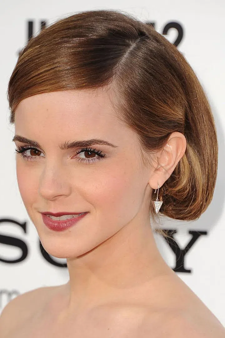 No, she didn't chop off her hair again. Watson tries out a faux bob at an event in 2013