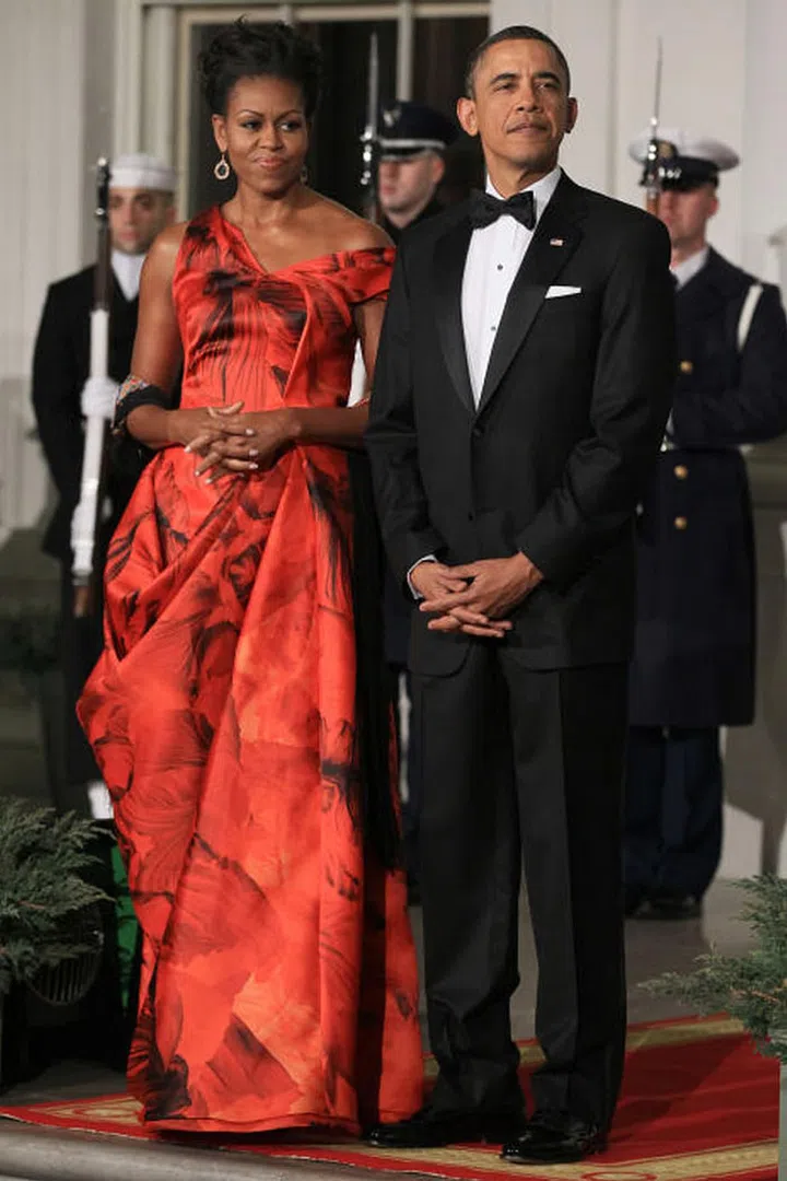 Michelle Obama is the definition of elegance in this stunning, red silk gown by Alexander McQueen.