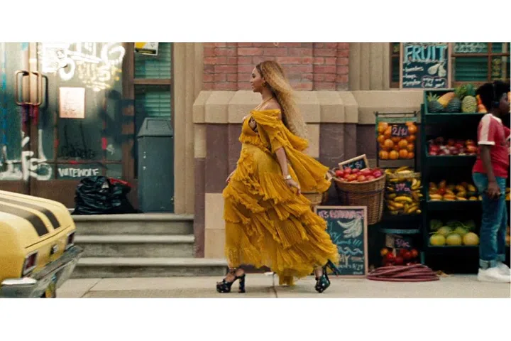 In a Roberto Cavalli dress and Saint Laurent platforms.
Photo: HBO