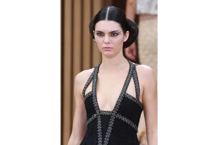 The hair stylist Sam McKnight referred to the wide, twisted updos that adorned every model as 'Chanel crossiants'. The make-up was equally as bold with graphic, black lines to frame the eyes ; Photo: Rex Features