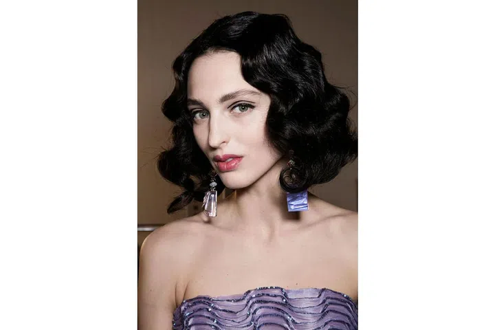 The make-up artist Linda Cantello defined the eyes with two well-placed, liquid lines at Armani Privé. For a uniform hair look, each model was fitted with a short, black, wavy wig ; Photo: Imaxtree