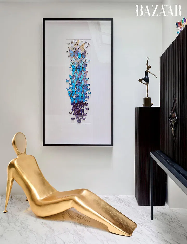 A La Pose chaise longue in the shape of a man and an artwork of Amazonian butterflies by Christopher Marley take pride of place in the lounge.