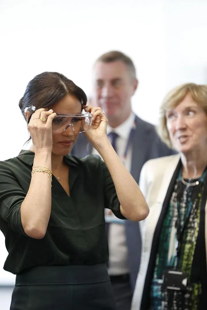 They also donned safety glasses to watch an experiment during a tour of an engineering laboratory.
