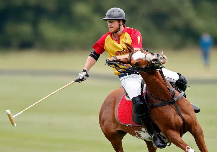 Prince Harry, 32, playing polo at a charity match at Cirencester Park Polo Club in Cirencester, England.