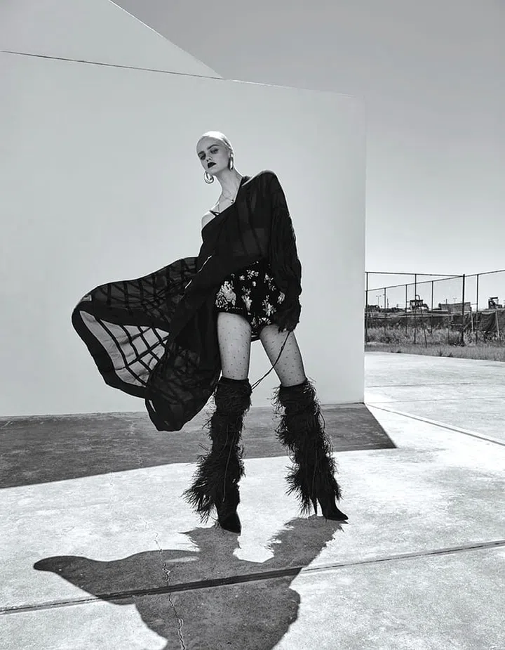 Painted cotton skirt, Prada. Metal earrings, Salvatore Ferragamo. Silk and leather boots, Off-White c/o Jimmy Choo. Bra; stockings, stylist’s own