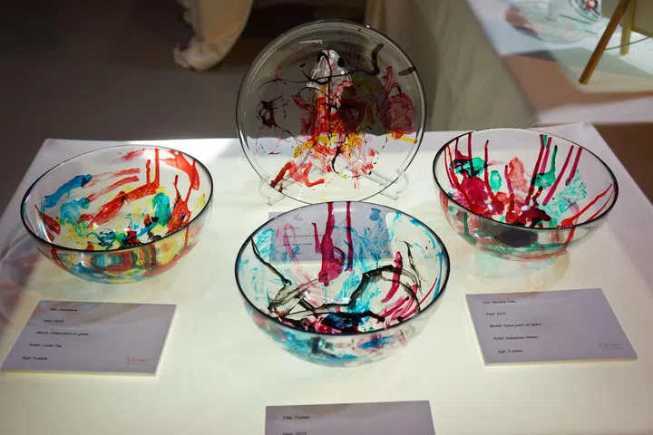Children experiment with different colours of glass paint to create masterpieces.
