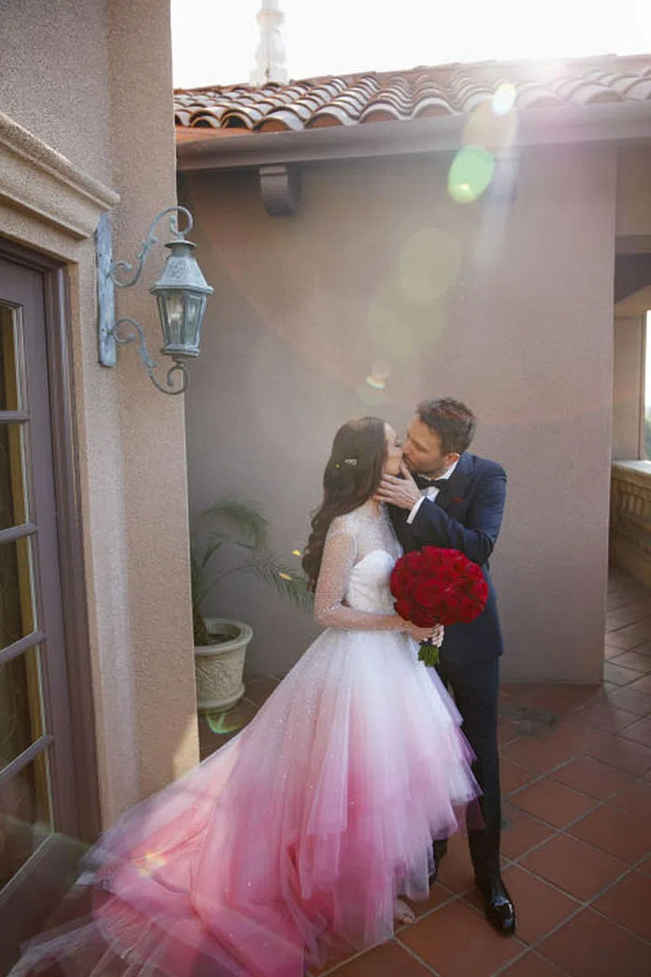 Along with her custom Christian Siriano ombré beaded wedding gown, the bride wore customized Stuart Weitzman nudist sandals with ombré pave crystals for the ceremony. In her hair, Lydia wore antique diamond hair pins, which were a wedding gift from Chris, who wore a custom Prada suit. Photo: Lara Porzak